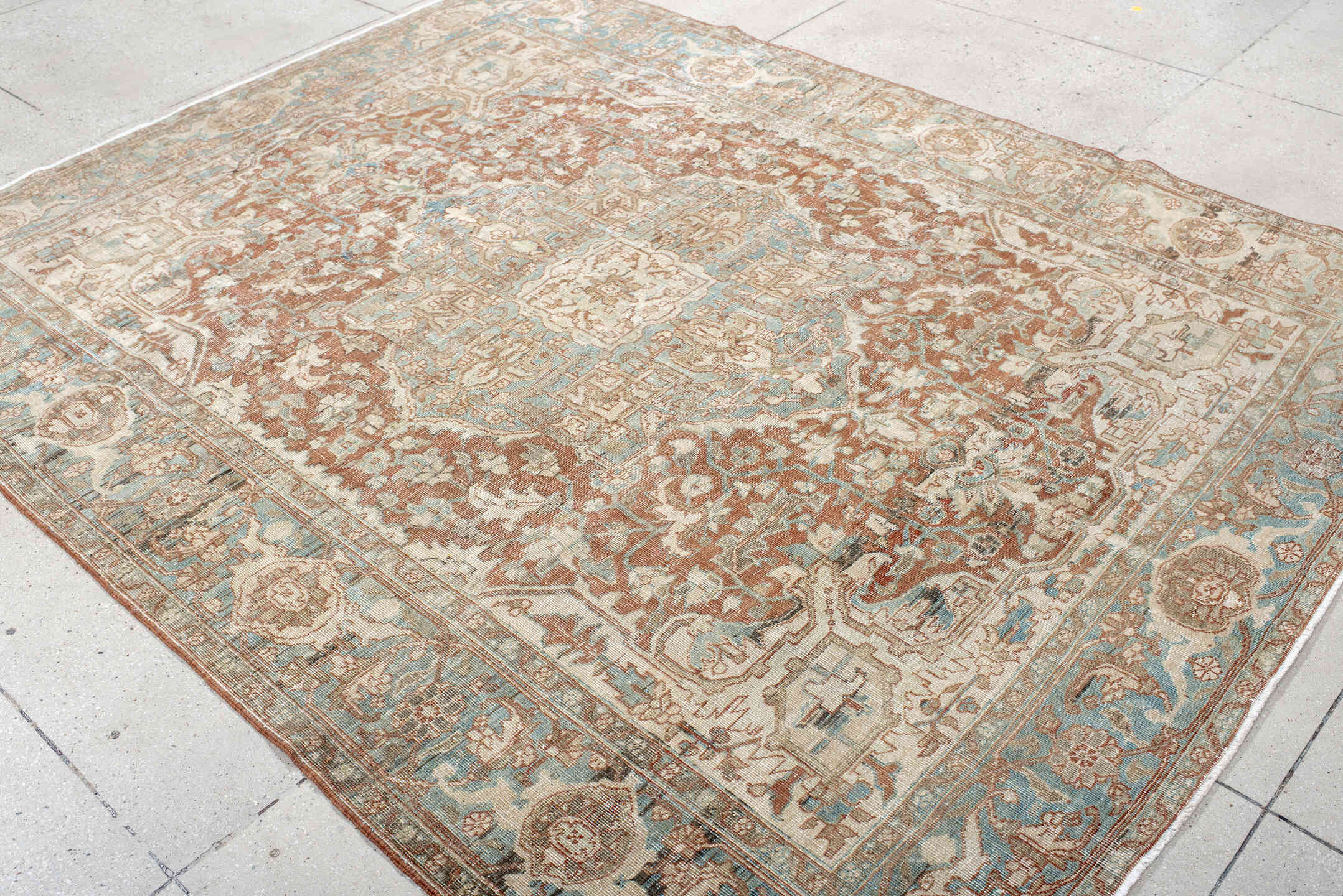 7' x 9' one-of-a-kind handmade antique Heriz rug. Color palette: ivory, sky blue, rust, taupe, camel, brown, light blue