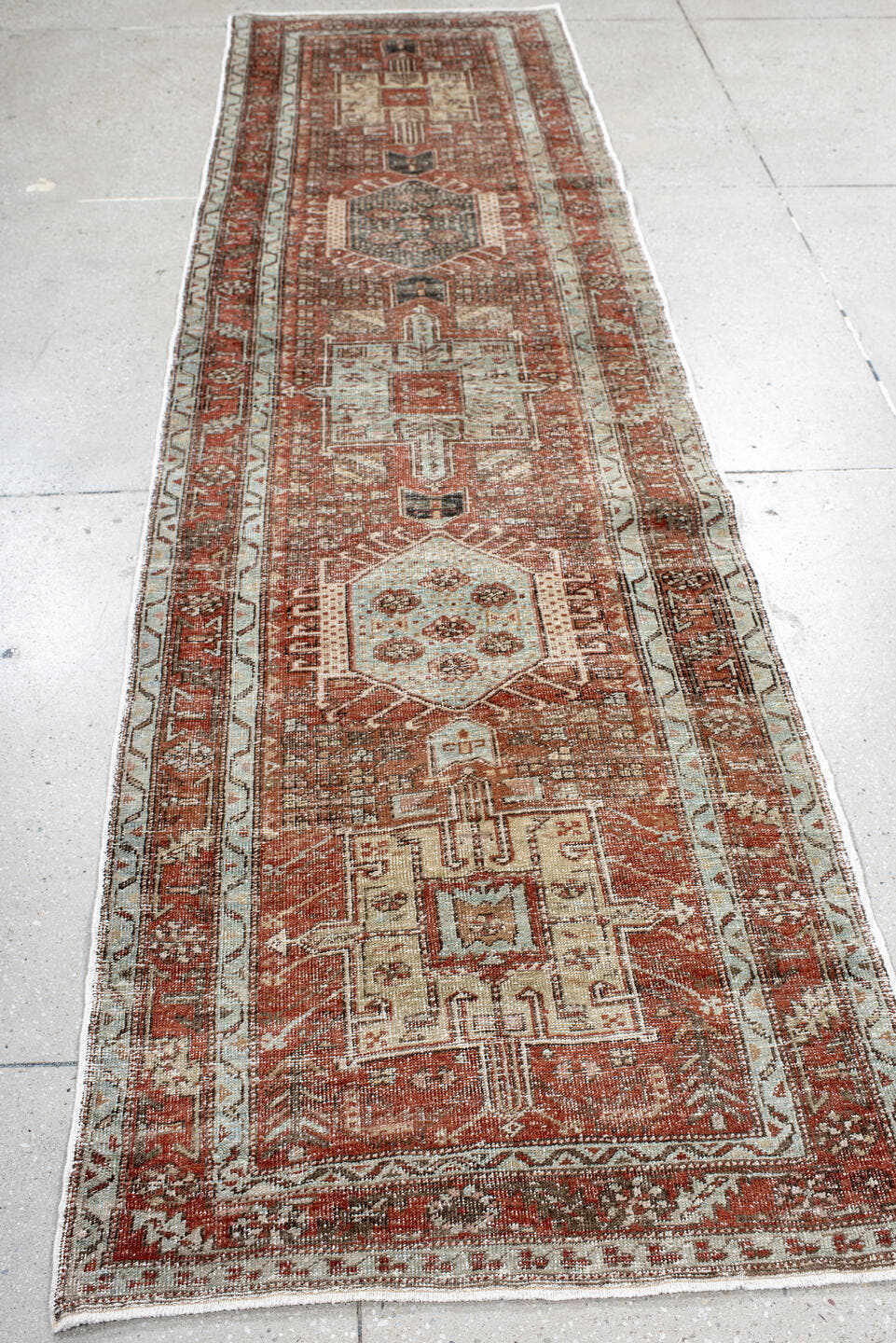 2' x 10' one-of-a-kind handmade antique Karaje runner rug. Color palette: rust, ivory, pale blue, taupe, charcoal, camel