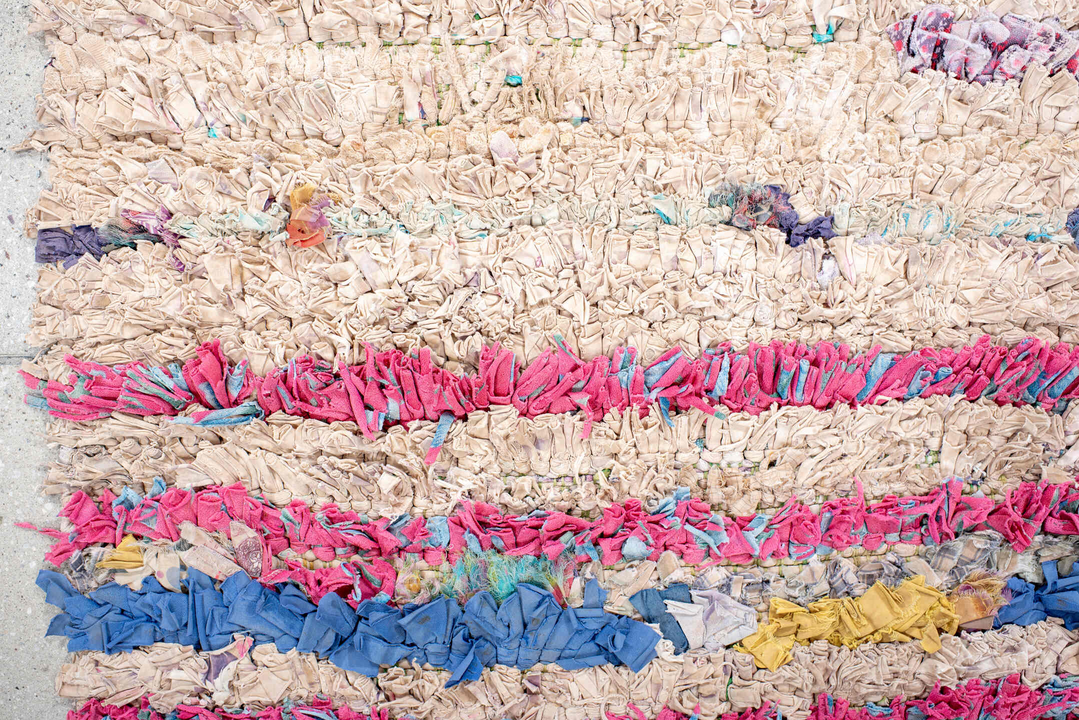 2' x 5' one-of-a-kind handmade vintage Rag Rug small size rug. Color palette: cream, pink, lavender, cobalt, charcoal, teal
