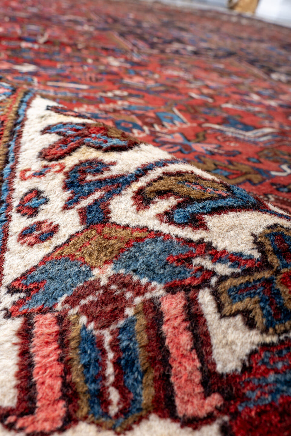 11' x 21' one-of-a-kind handmade antique Heriz oversize rug. Color palette: rust, ivory, navy, cobalt, terra cotta, charcoal