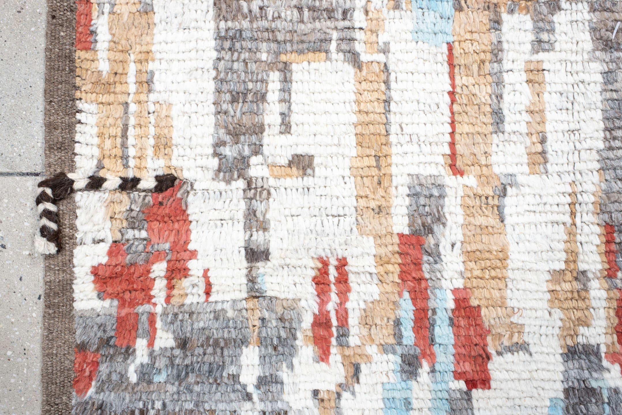 7' x 9' one-of-a-kind handmade vintage Tulu rug. Color palette: ivory, terra cotta, gray, pale aqua, camel, brown