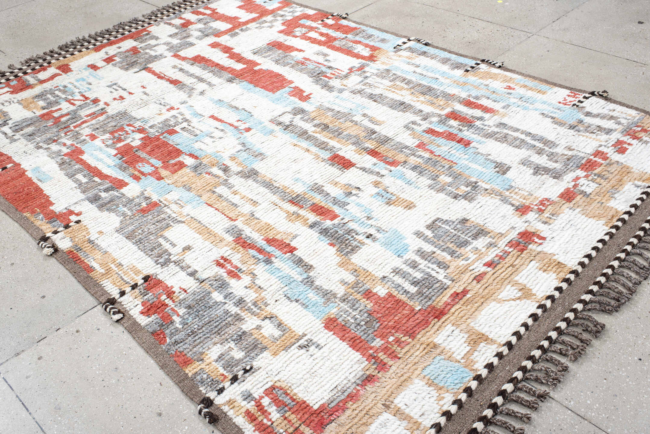 7' x 9' one-of-a-kind handmade vintage Tulu rug. Color palette: ivory, terra cotta, gray, pale aqua, camel, brown