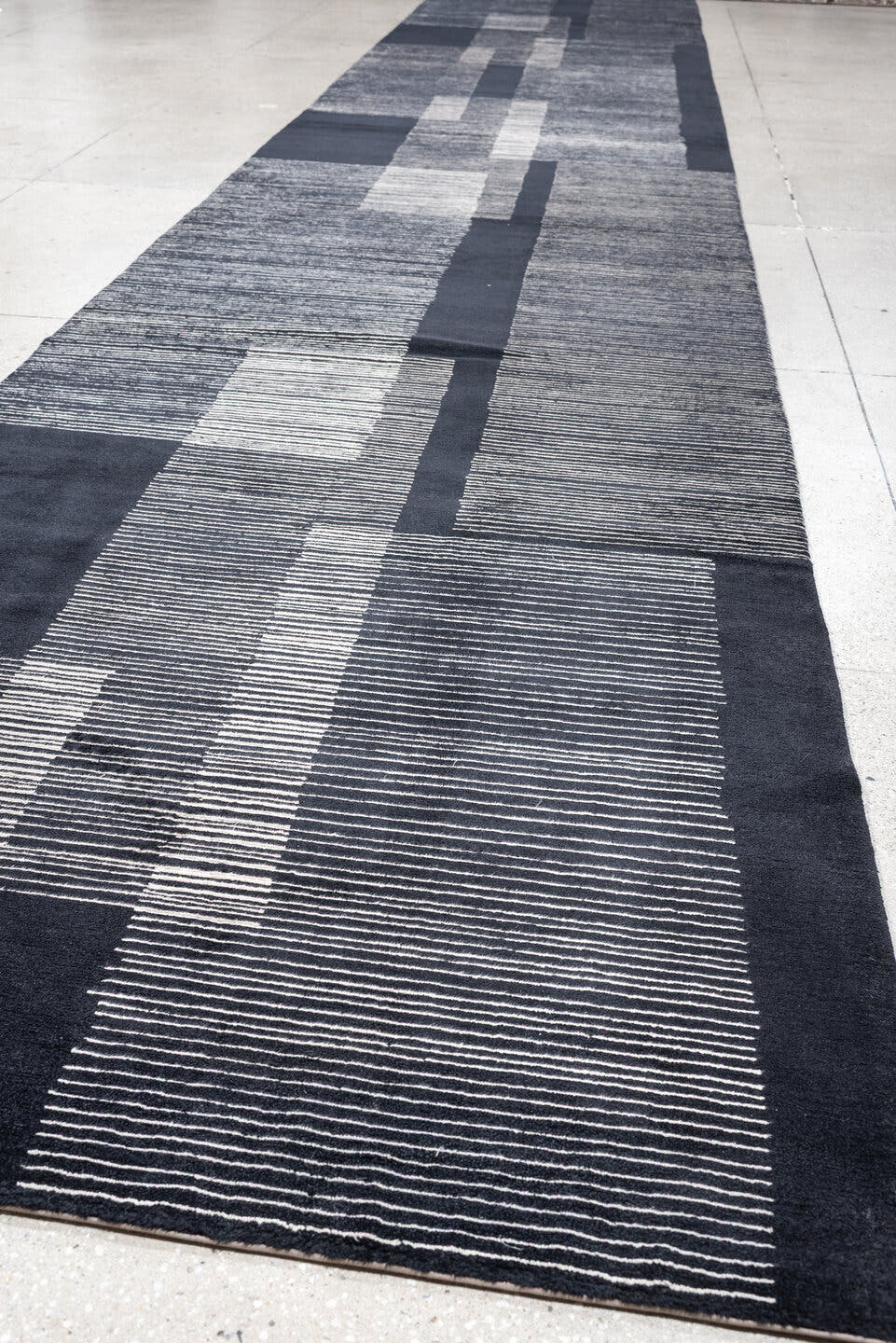 4' x 22' one-of-a-kind handmade antique Tibetan runner rug. Color palette: charcoal, slate, ivory, pewter, ebony, black