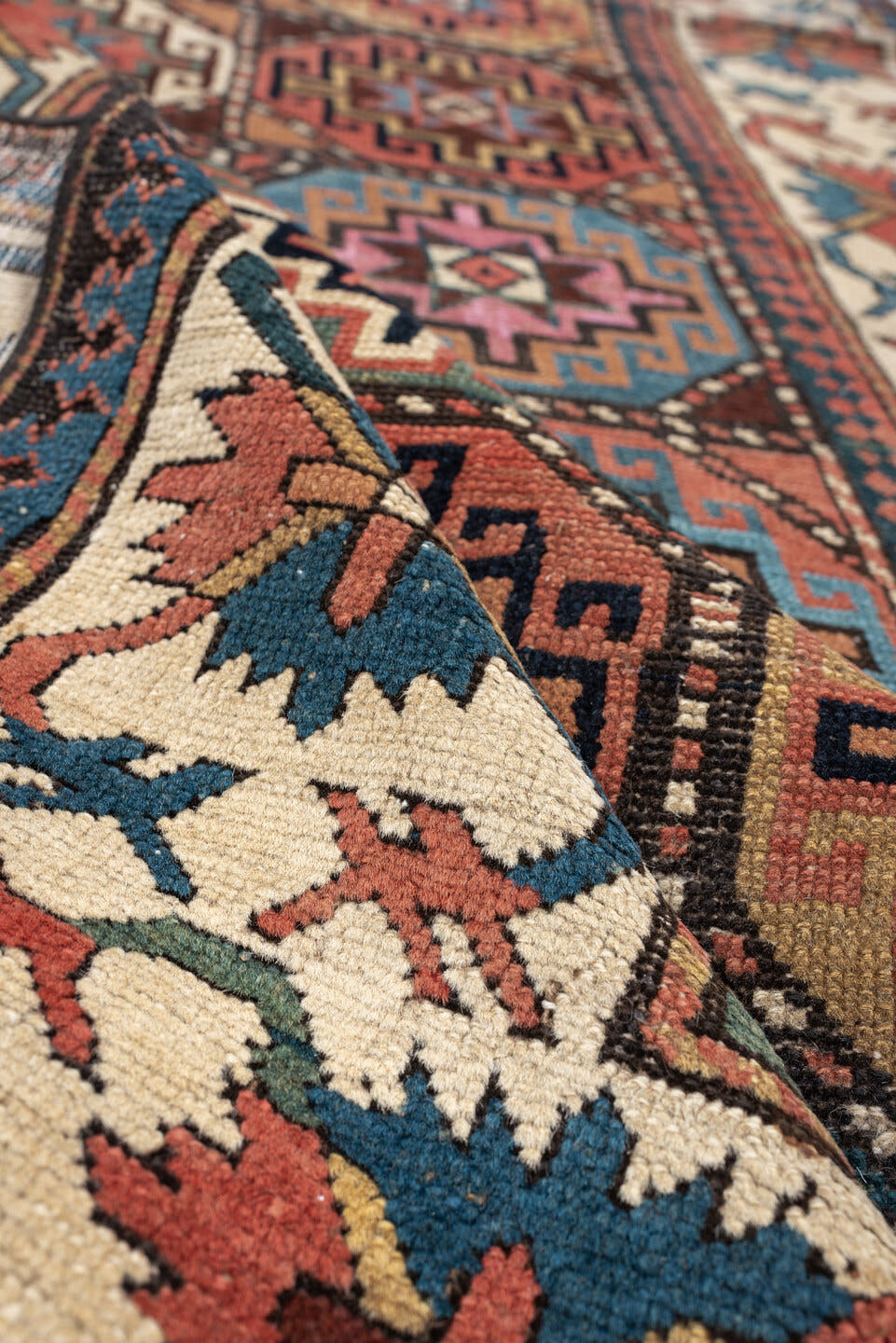 3' x 13' one-of-a-kind handmade antique Caucasian runner rug. Color palette: indigo, ivory, rust, coral, teal, charcoal