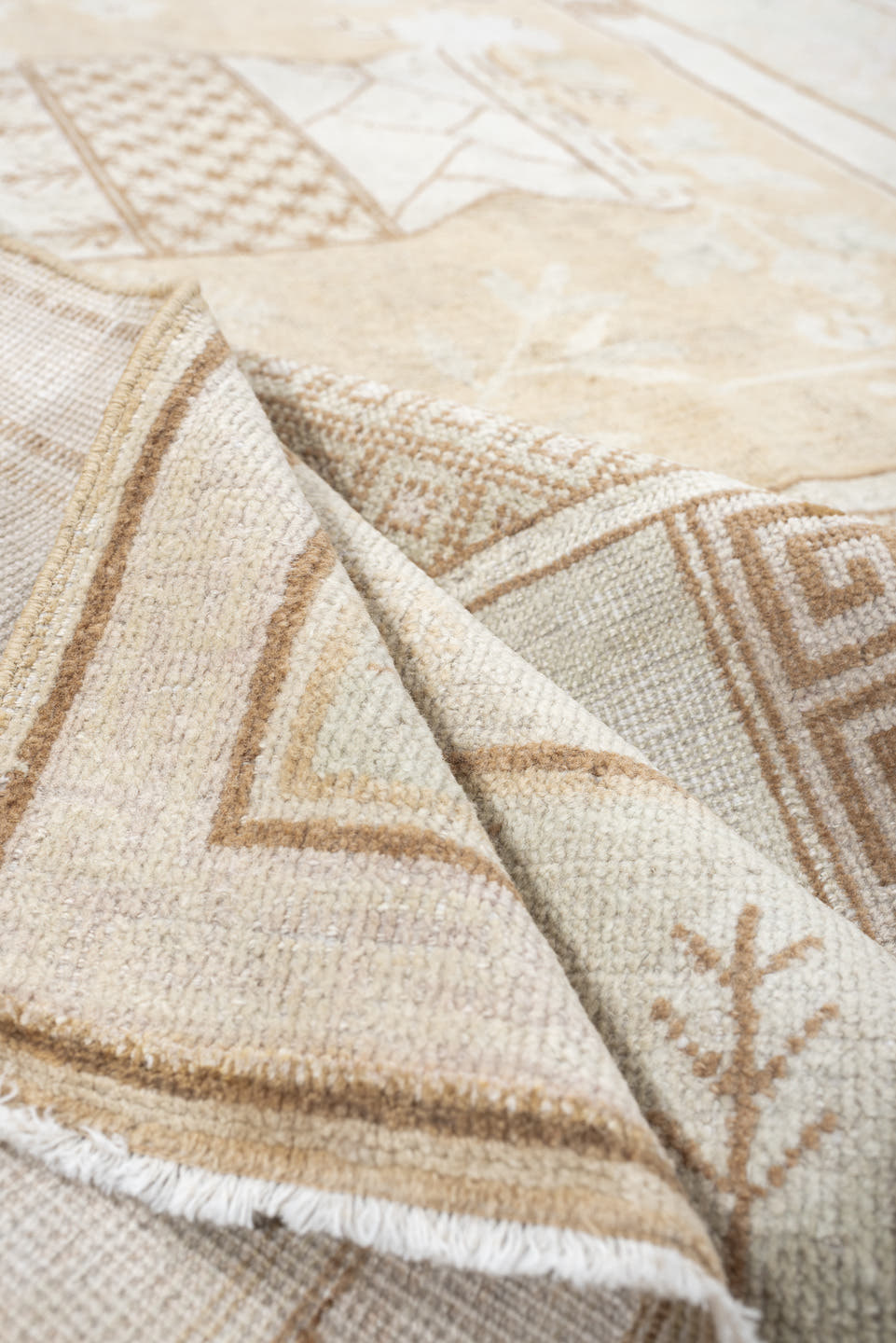 5' x 9' one-of-a-kind handmade antique Khotan medium size rug. Color palette: ivory, sand, celadon, beige, taupe, camel