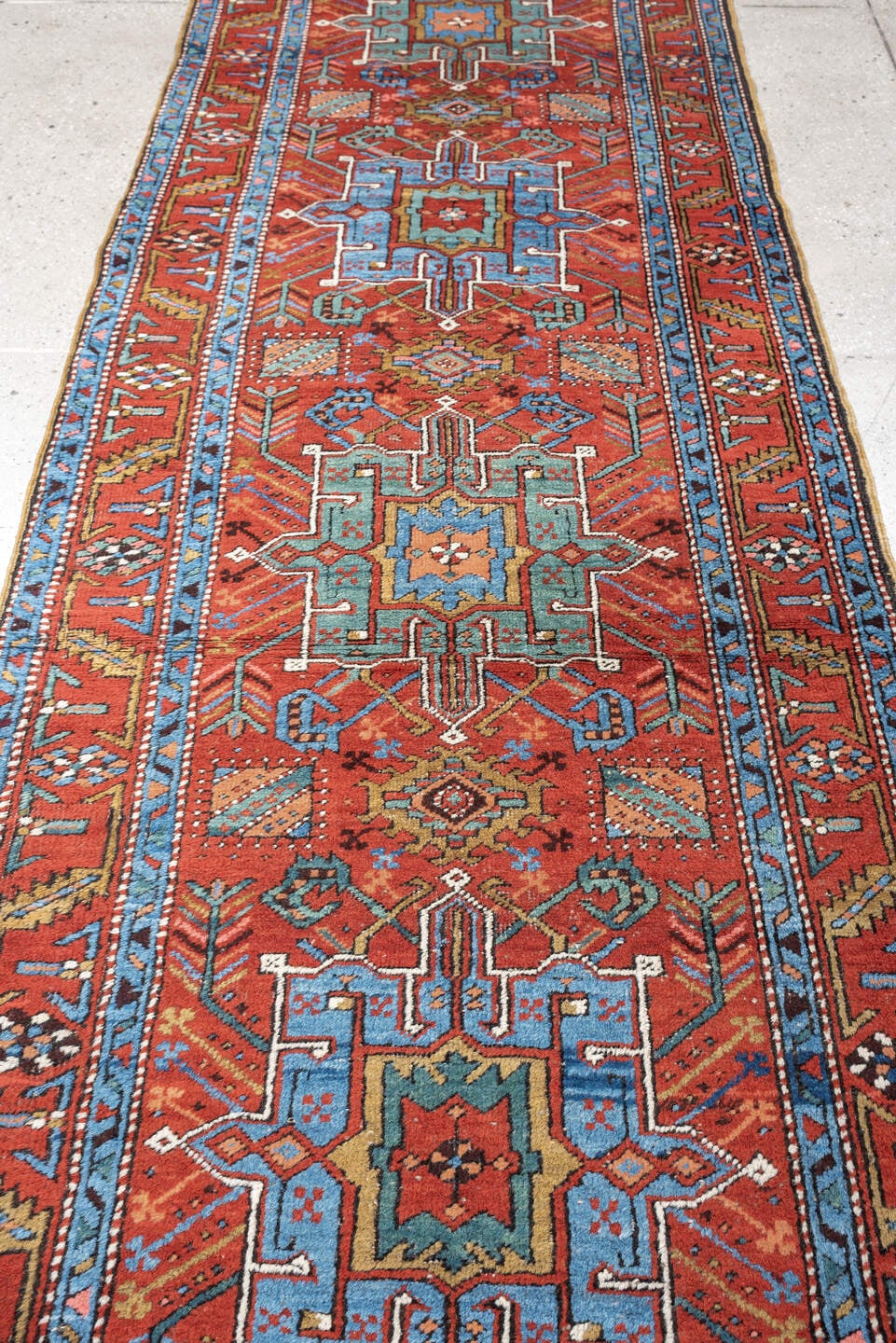 3' x 10' one-of-a-kind handmade antique Heriz runner rug. Color palette: rust, turquoise, sky blue, ivory, coral, navy, sage