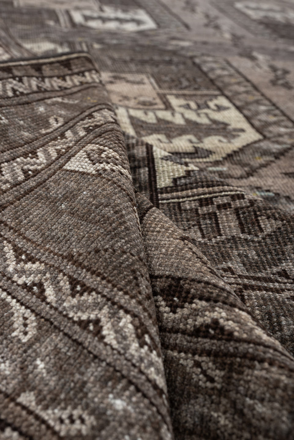 7' x 10' one-of-a-kind handmade antique Afghan large size rug. Color palette: taupe, brown, ivory, charcoal, slate, camel