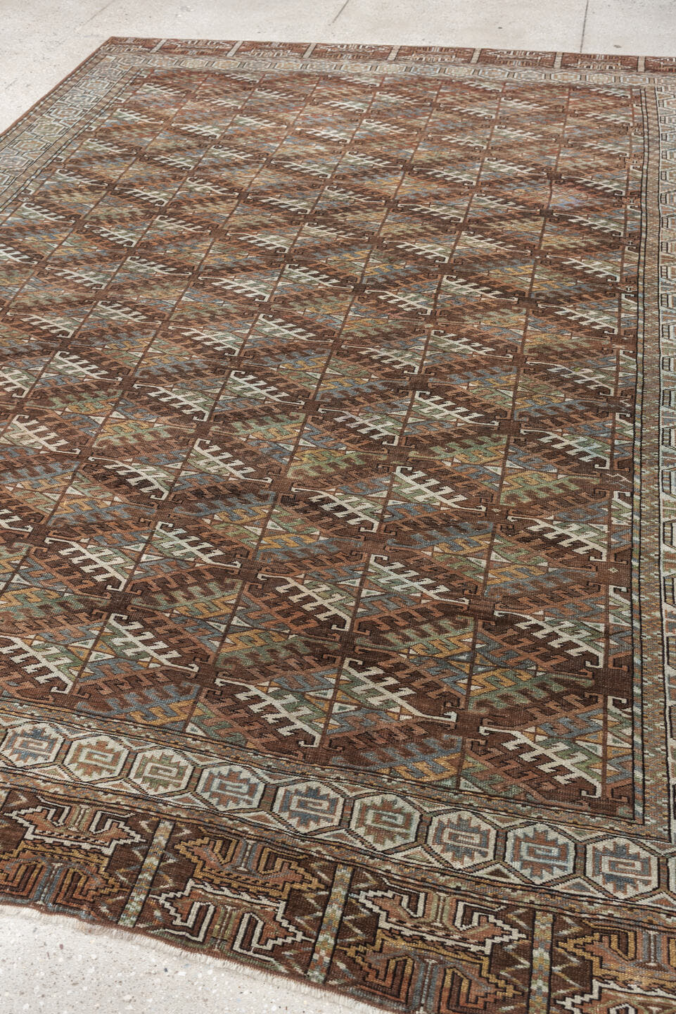 7' x 10' one-of-a-kind handmade antique Yamoud large size rug. Color palette: brown, camel, ivory, muted teal, rust, taupe