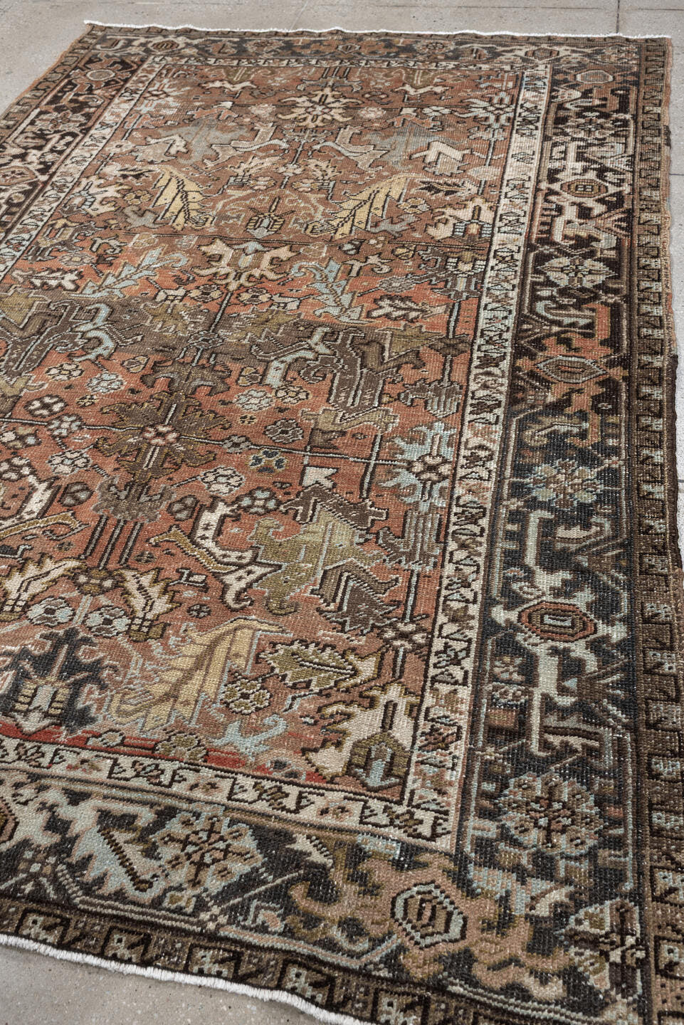 5' x 8' one-of-a-kind handmade antique Heriz medium size rug. Color palette: terra cotta, charcoal, ivory, olive, camel