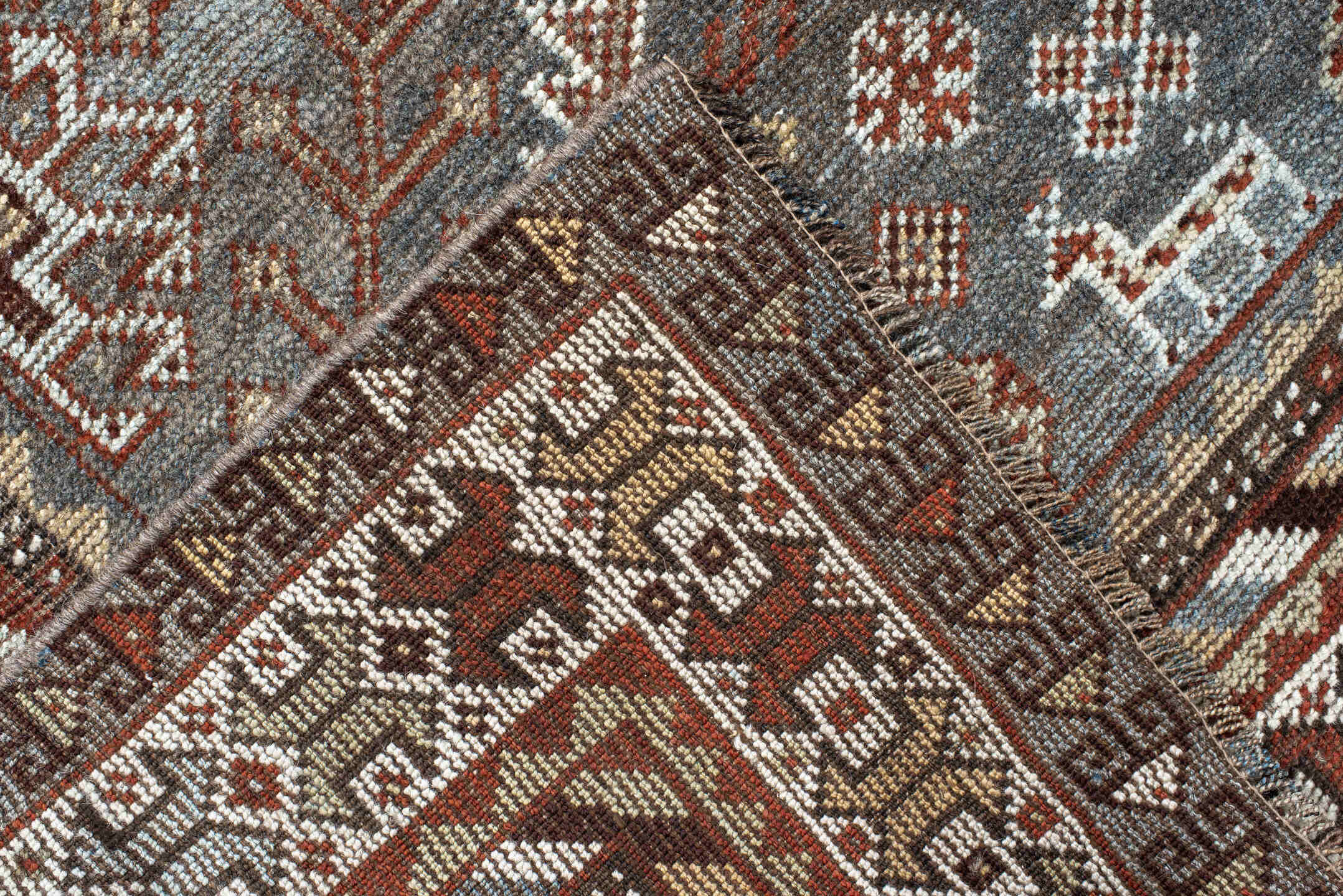 4' x 9' one-of-a-kind handmade antique Shiraz rug. Color palette: rust, sky blue, ivory, brown, taupe, charcoal, terracotta