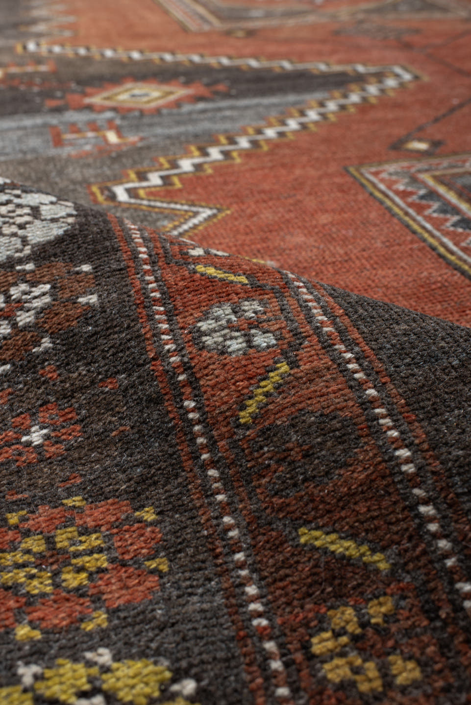 5' x 8' one-of-a-kind handmade vintage Veece medium size rug. Color palette: rust, charcoal, slate, brown, ivory, gold