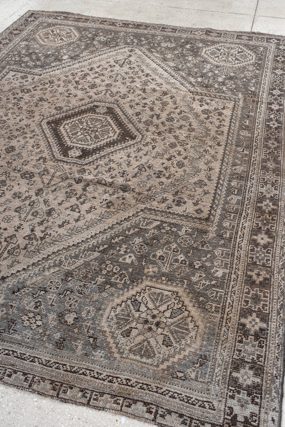 7' x 9' one-of-a-kind handmade vintage Shiraz rug. Color palette: ivory, taupe, brown, slate, charcoal, camel, beige, gray