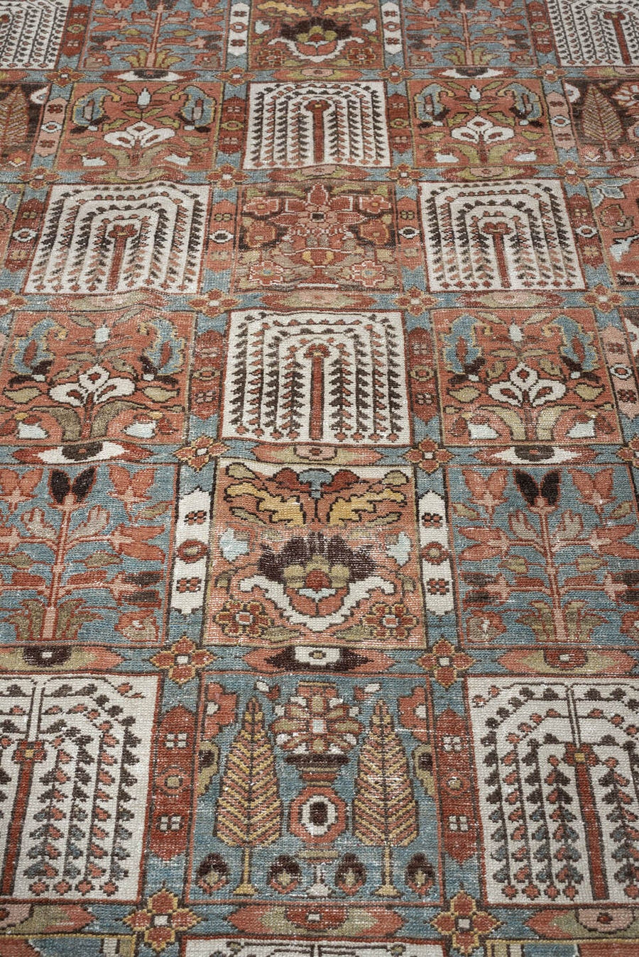 6' x 9' one-of-a-kind handmade antique Baktiary large size rug. Color palette: terracotta, ivory, blue gray, rust, brown