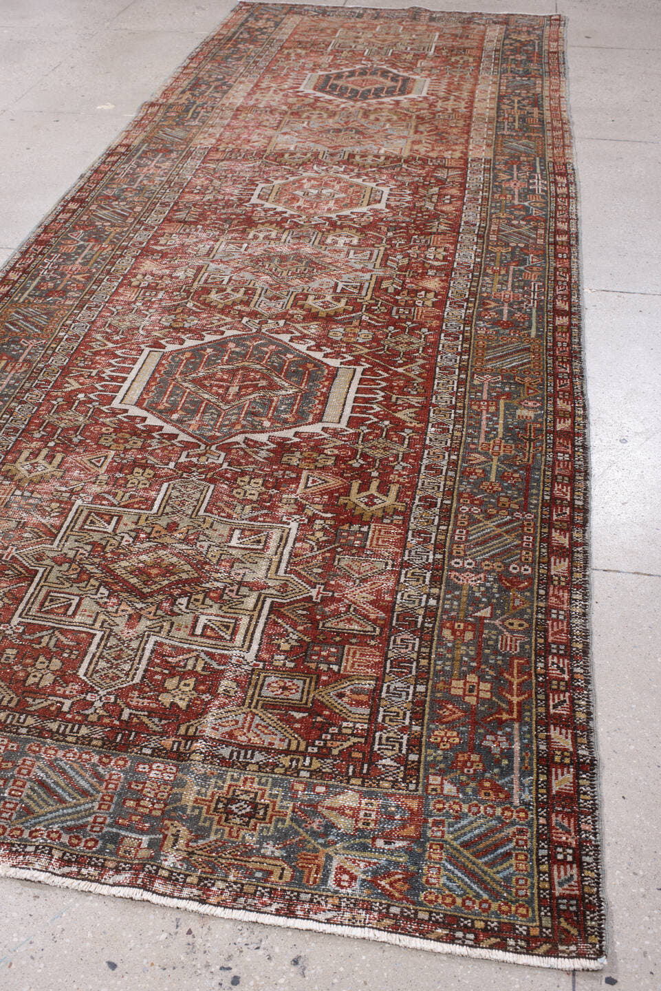 4' x 13' one-of-a-kind handmade antique Karaje runner rug. Color palette: rust, indigo, ivory, terracotta, charcoal, sienna