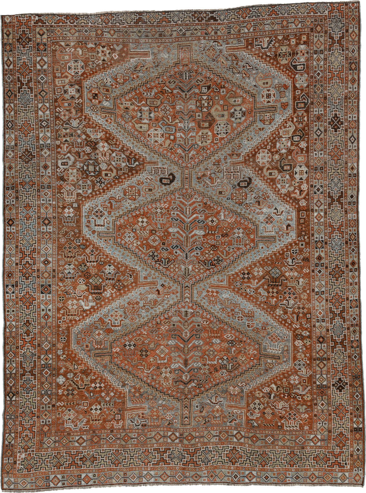 7' x 9' one-of-a-kind handmade antique Shiraz rug. Color palette: rust, pale blue gray, ivory, charcoal, terracotta, camel