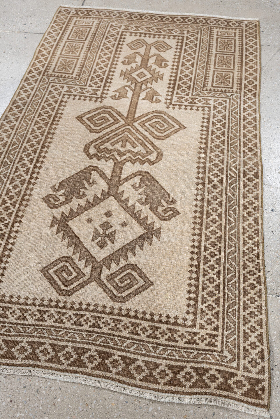 2' x 4' one-of-a-kind handmade antique Belouch small size rug. Color palette: ivory, taupe, camel, brown, beige, gray