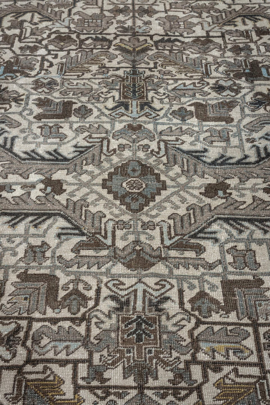 7' x 9' one-of-a-kind handmade antique Heriz large size rug. Color palette: ivory, charcoal, taupe, slate blue, olive, camel
