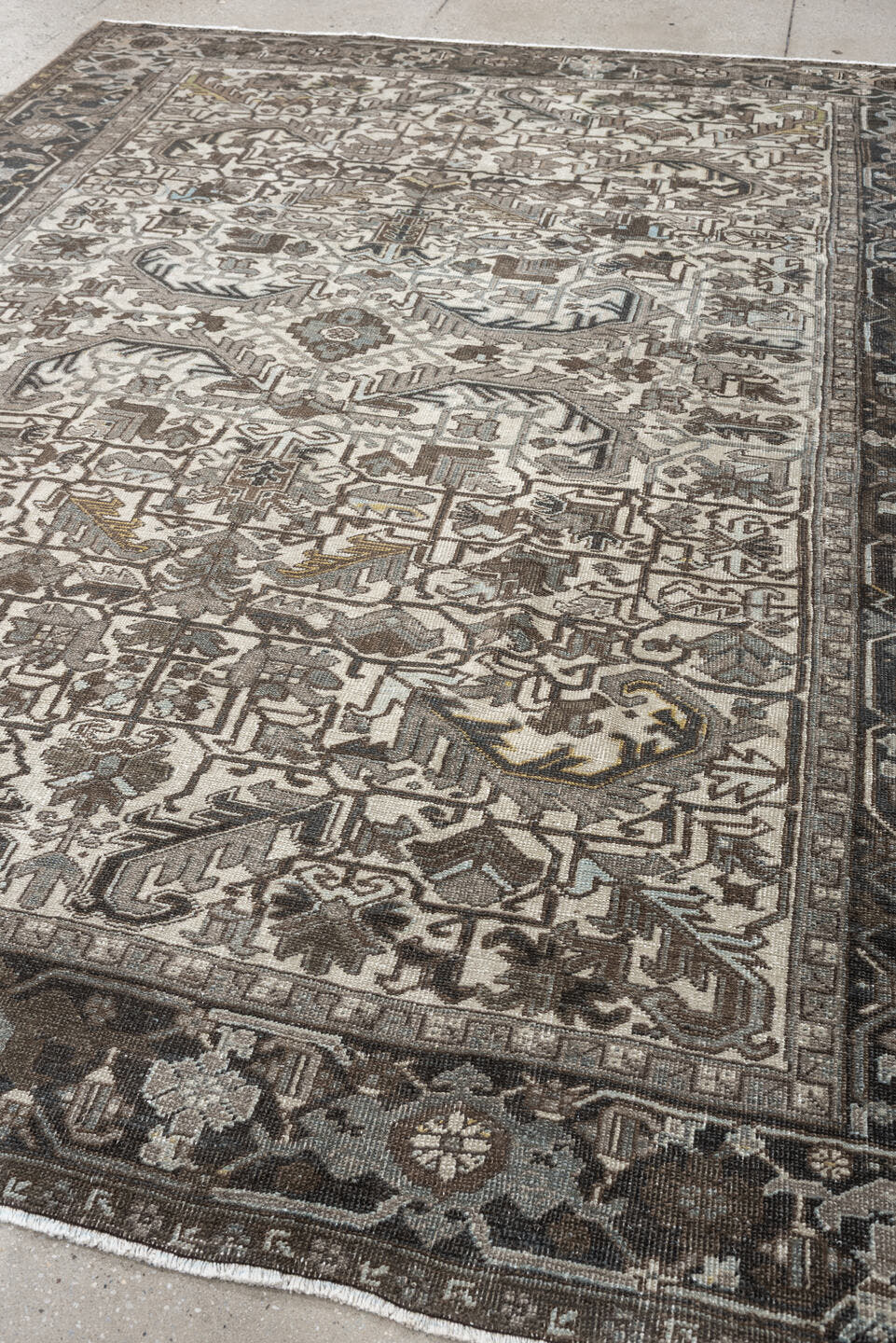 7' x 9' one-of-a-kind handmade antique Heriz large size rug. Color palette: ivory, charcoal, taupe, slate blue, olive, camel