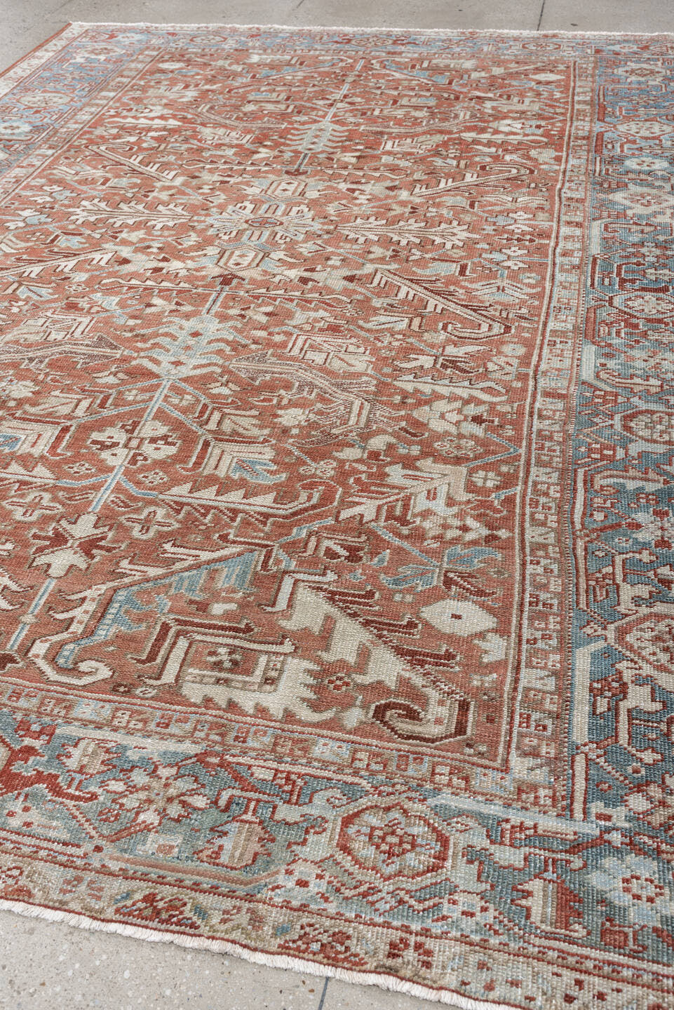 7' x 10' one-of-a-kind handmade antique Heriz large size rug. Color palette: terra cotta, ivory, blue gray, rust, pale blue