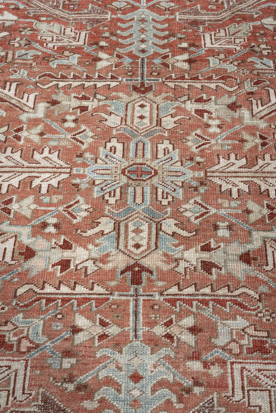 7' x 10' one-of-a-kind handmade antique Heriz large size rug. Color palette: terra cotta, ivory, blue gray, rust, pale blue