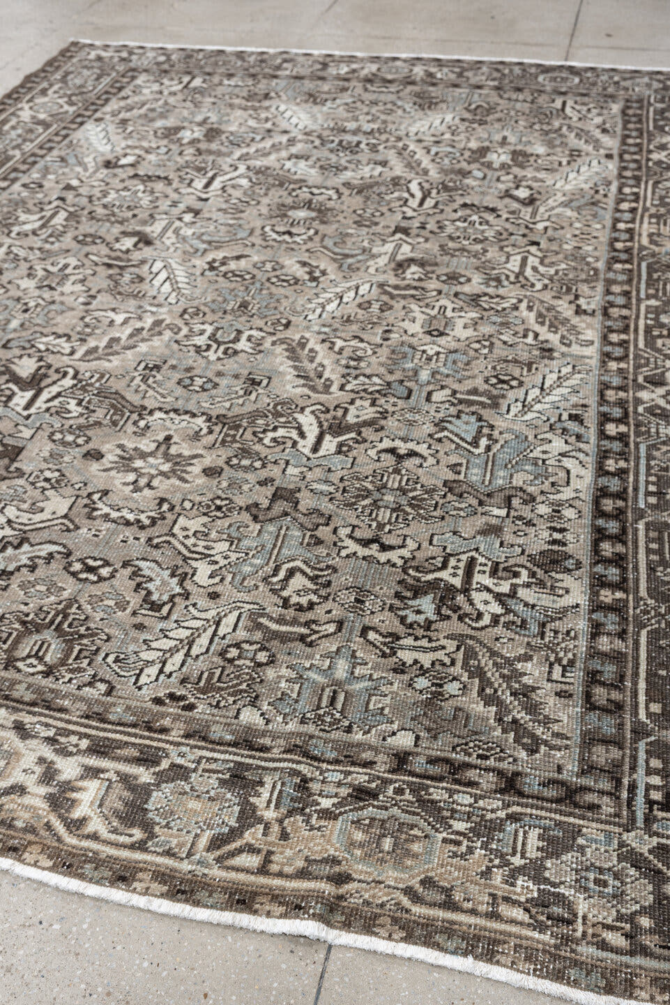 7' x 9' one-of-a-kind handmade antique Heriz large size rug. Color palette: ivory, taupe, charcoal, pale blue, gray, brown