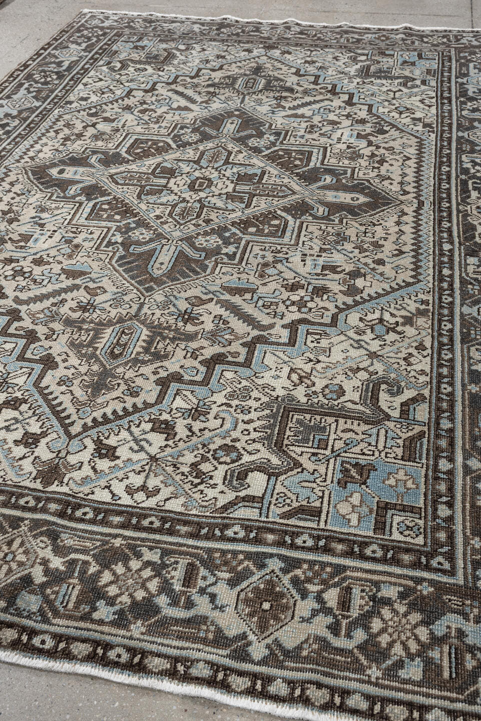 6' x 9' one-of-a-kind handmade antique Heriz medium size rug. Color palette: ivory, charcoal brown, pale blue, taupe, brown