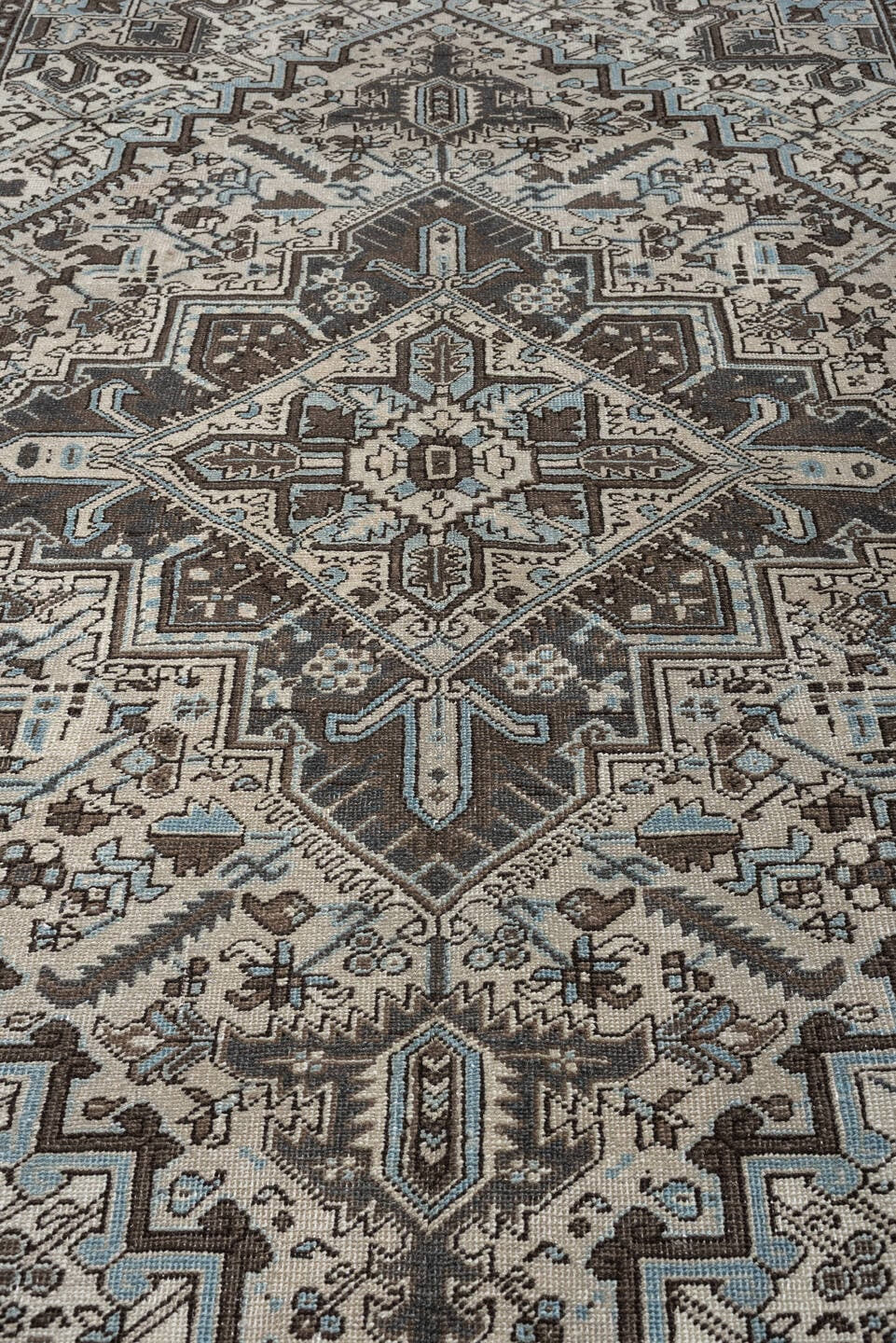 6' x 9' one-of-a-kind handmade antique Heriz medium size rug. Color palette: ivory, charcoal brown, pale blue, taupe, brown