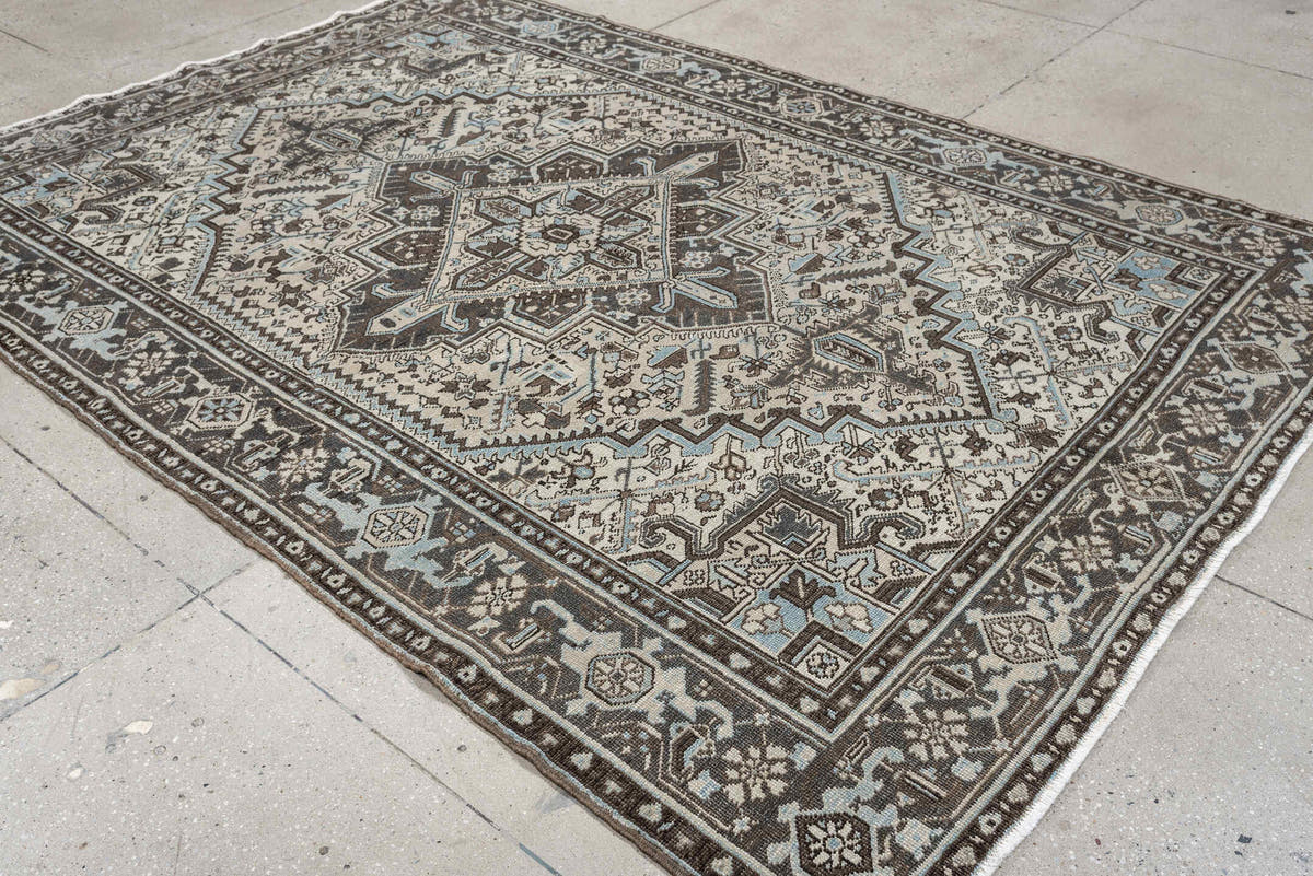 6' x 9' one-of-a-kind handmade antique Heriz medium size rug. Color palette: ivory, charcoal brown, pale blue, taupe, brown
