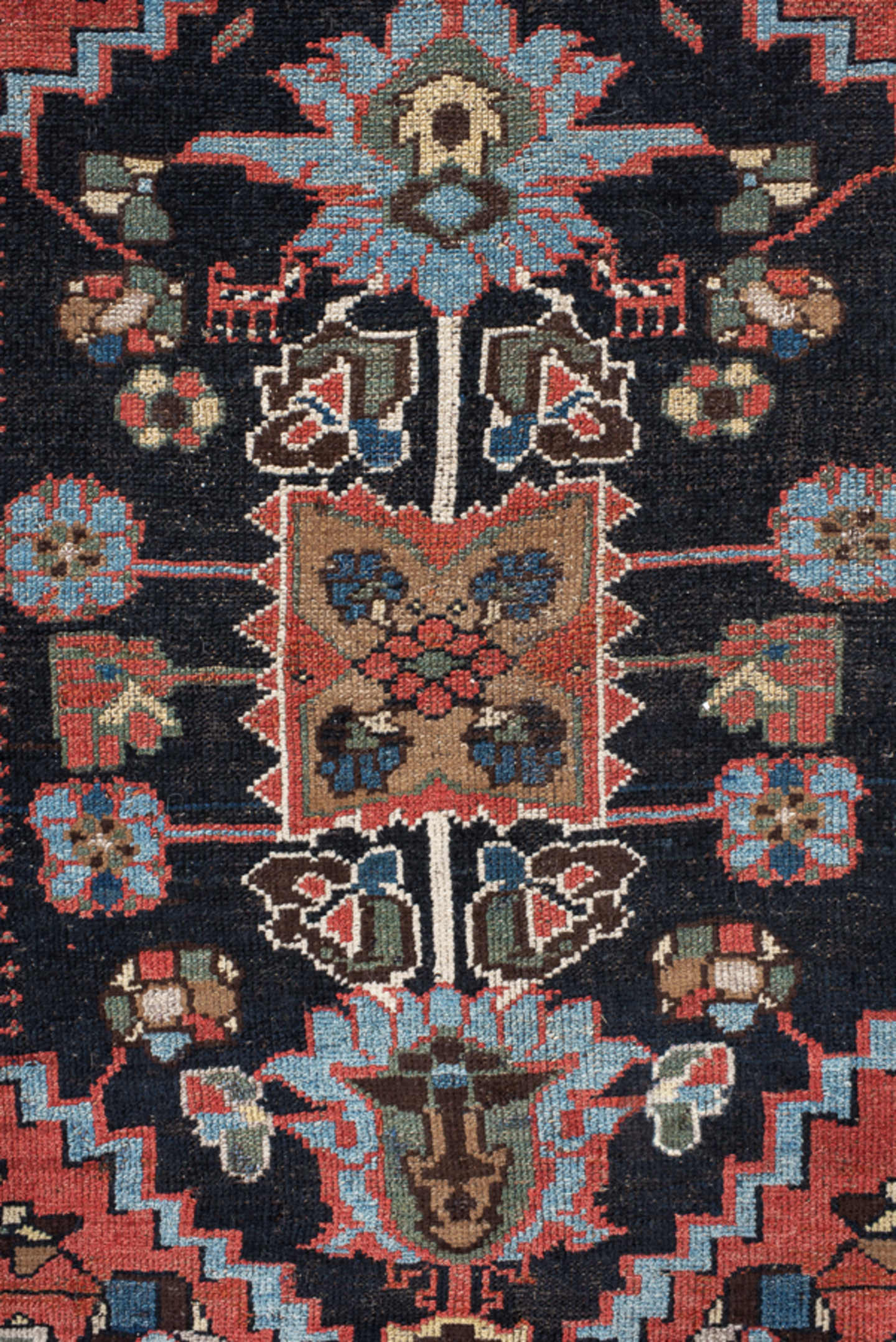 4' x 8' one-of-a-kind handmade vintage rug. Color palette: navy, rust, ivory, sky blue, black, crimson, sage, camel, blue