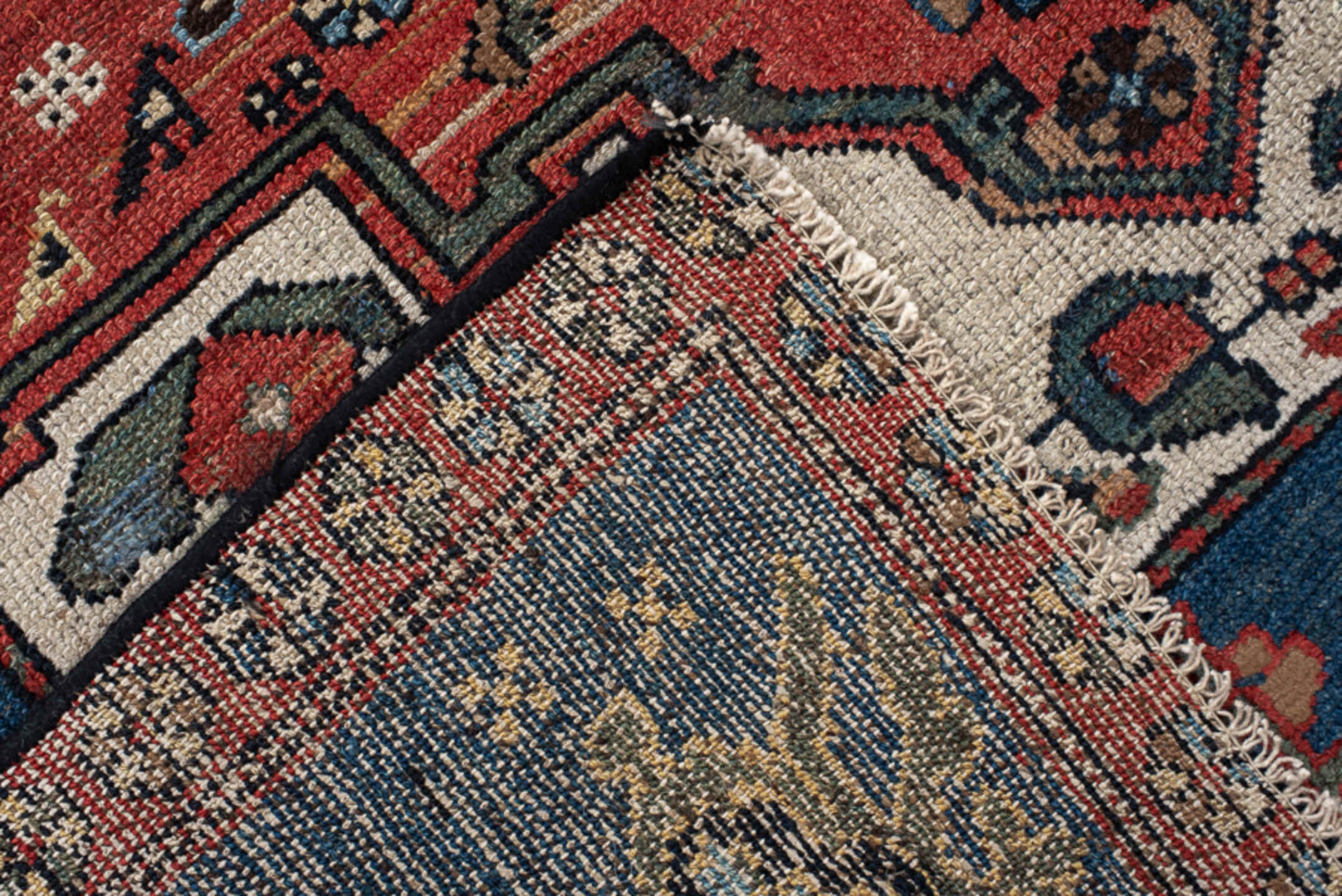 4' x 8' one-of-a-kind handmade vintage rug. Color palette: navy, rust, ivory, sky blue, black, crimson, sage, camel, blue