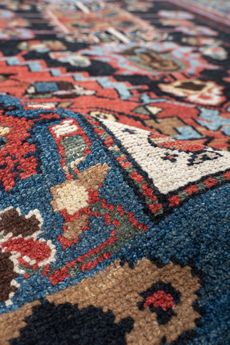 4' x 8' one-of-a-kind handmade vintage rug. Color palette: navy, rust, ivory, sky blue, black, crimson, sage, camel, blue
