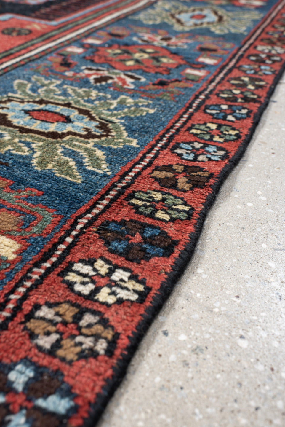 4' x 8' one-of-a-kind handmade vintage rug. Color palette: navy, rust, ivory, sky blue, black, crimson, sage, camel, blue