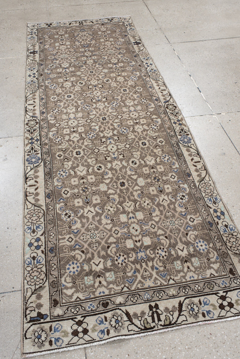 3' x 9' one-of-a-kind handmade vintage runner rug. Color palette: taupe, ivory, brown, blue, charcoal, beige, gray, black