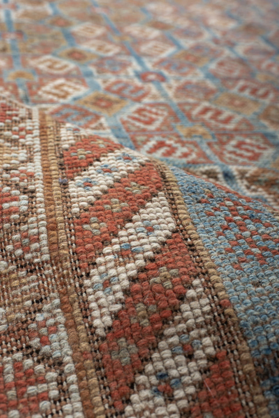 4' x 7' one-of-a-kind handmade vintage Shiraz rug. Color palette: terra cotta, camel, blue, ivory, rust, taupe, terracotta