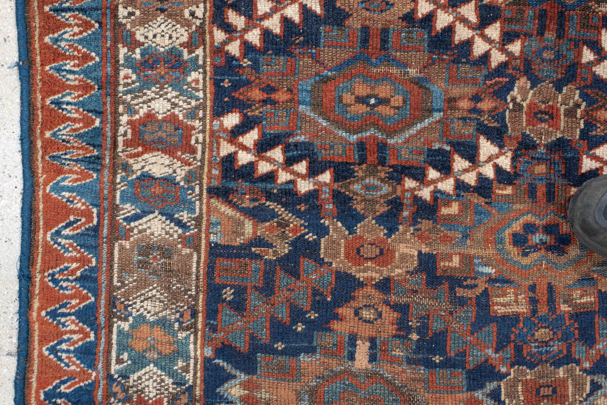 4' x 7' one-of-a-kind handmade vintage Kurd rug. Color palette: navy, rust, ivory, camel, sky blue, taupe, terracotta, blue