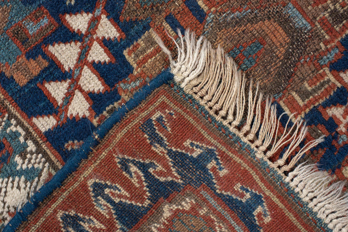 4' x 7' one-of-a-kind handmade vintage Kurd rug. Color palette: navy, rust, ivory, camel, sky blue, taupe, terracotta, blue