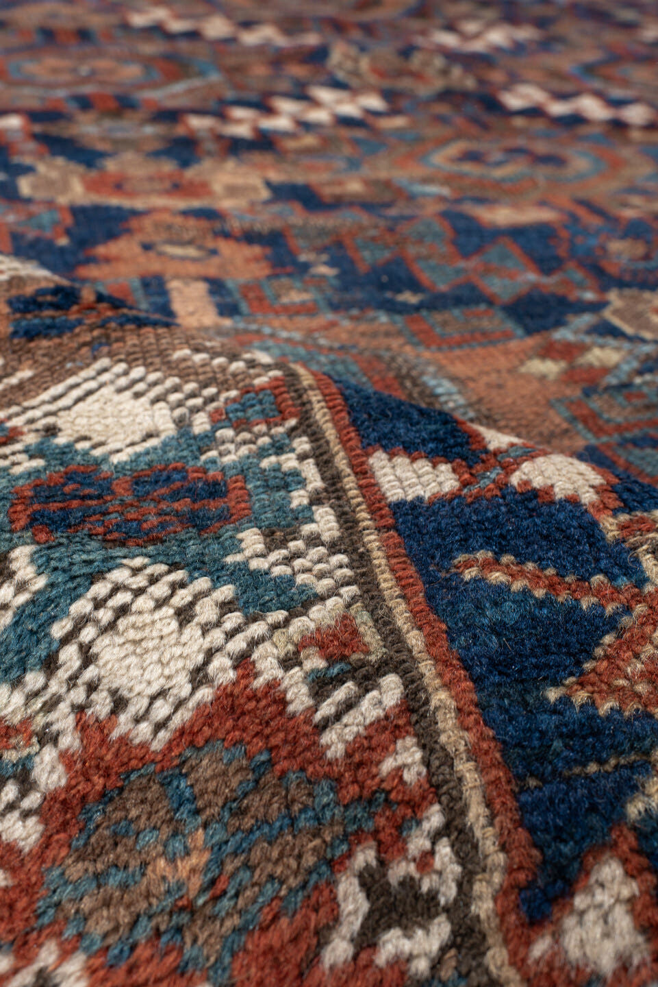 4' x 7' one-of-a-kind handmade vintage Kurd rug. Color palette: navy, rust, ivory, camel, sky blue, taupe, terracotta, blue