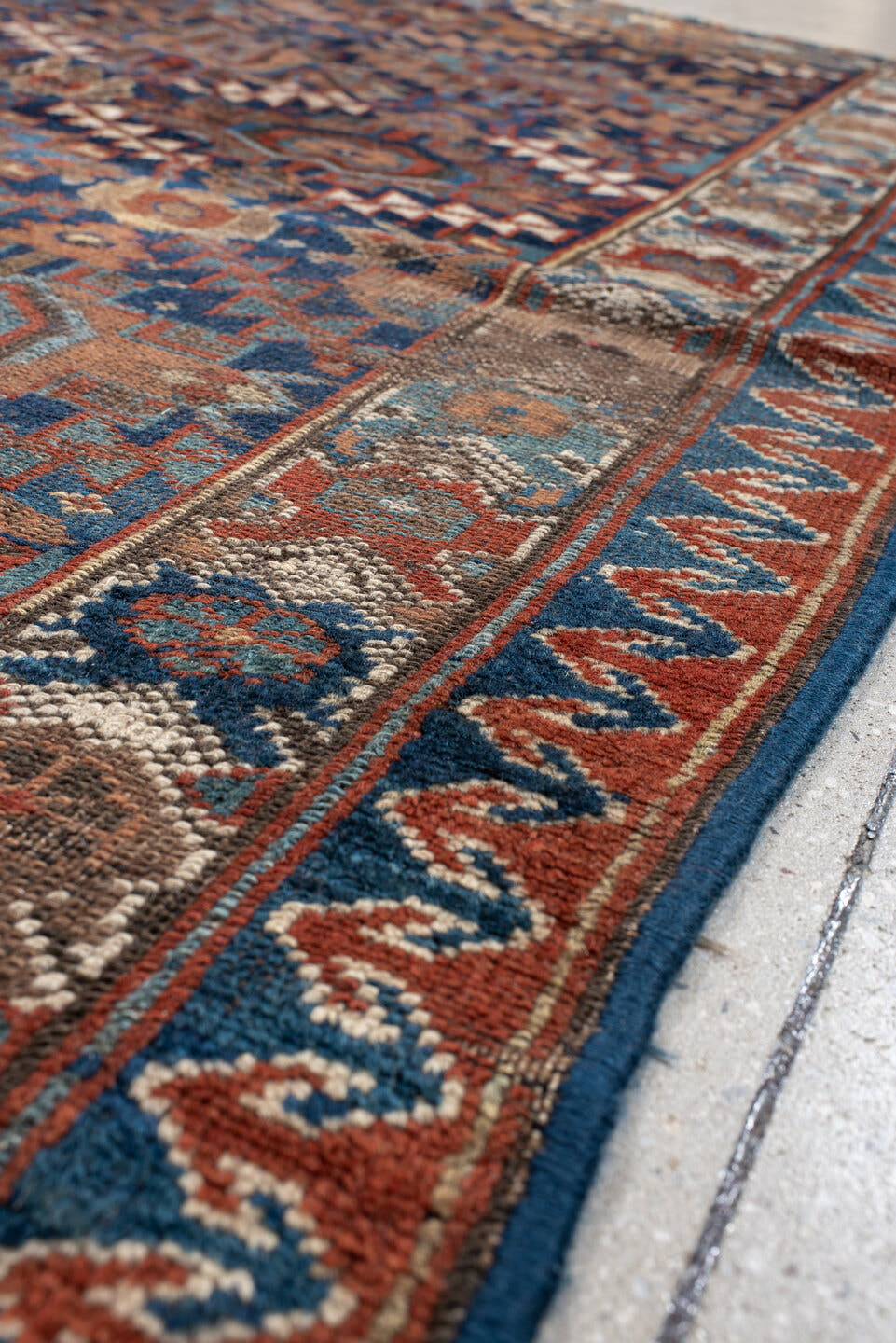4' x 7' one-of-a-kind handmade vintage Kurd rug. Color palette: navy, rust, ivory, camel, sky blue, taupe, terracotta, blue