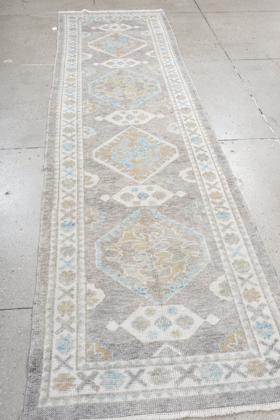 3' x 10' one-of-a-kind handmade vintage runner rug. Color palette: dark gray, gainsboro, gray, light blue, light gray