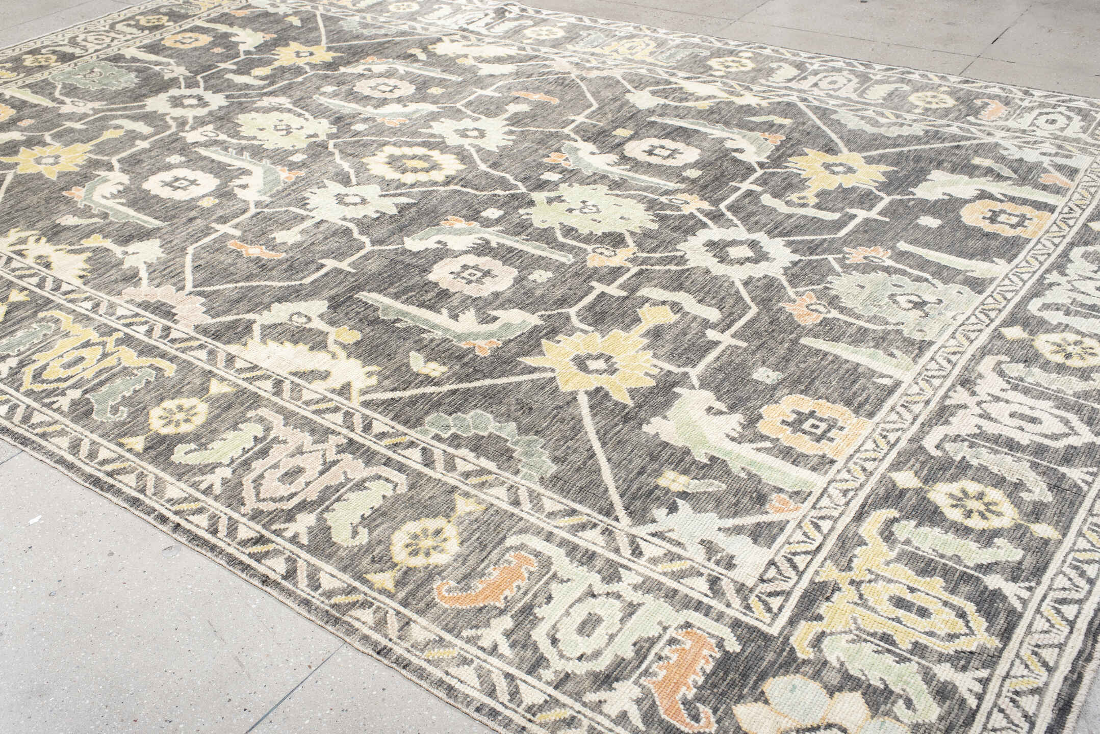 9' x 15' one-of-a-kind handmade vintage Oushak rug. Color palette: charcoal, ivory, sage, gold, peach, taupe, gray, black
