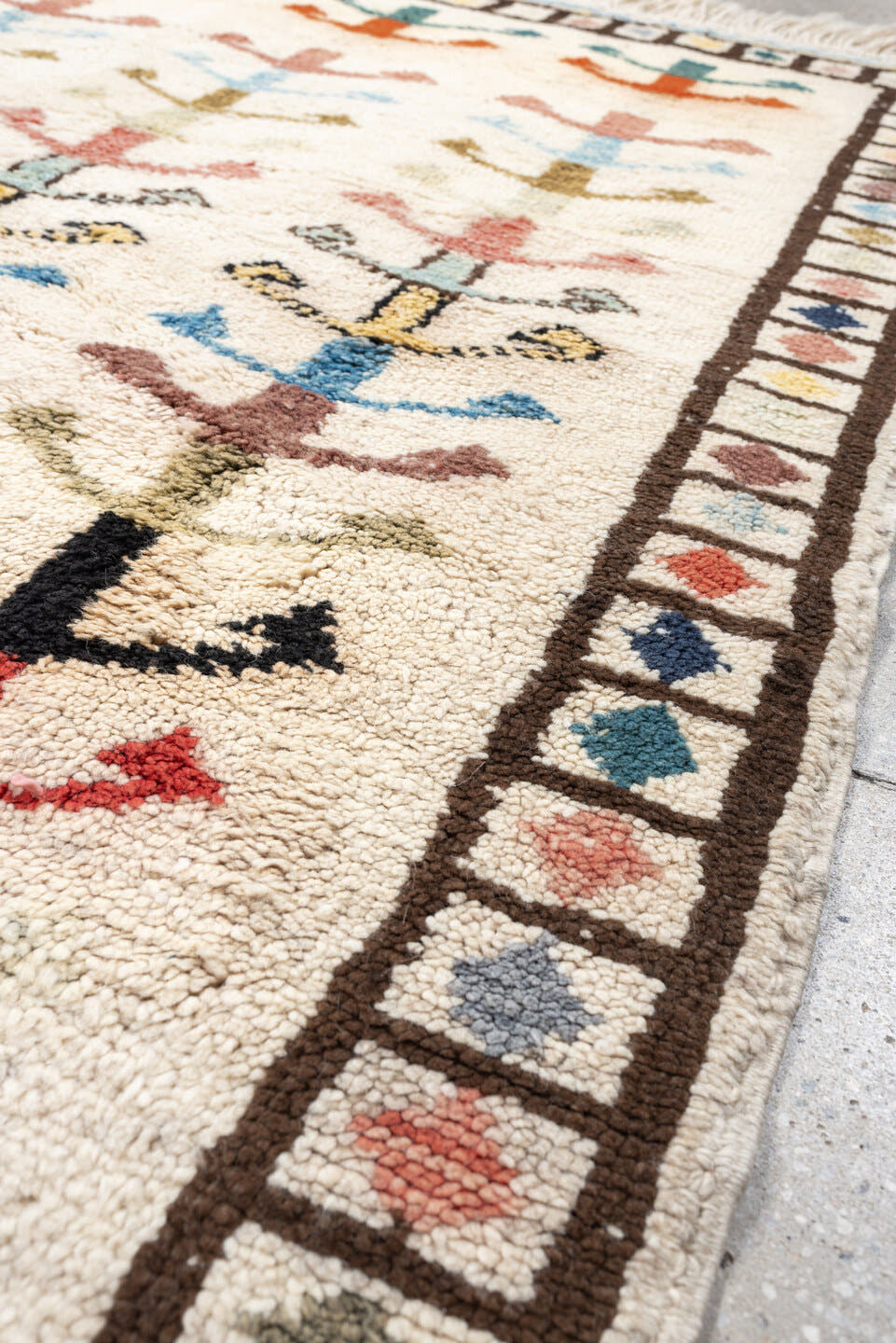 5' x 7' one-of-a-kind handmade vintage Tulu rug. Color palette: ivory, brown, sky blue, coral, blush, mustard, black, sage