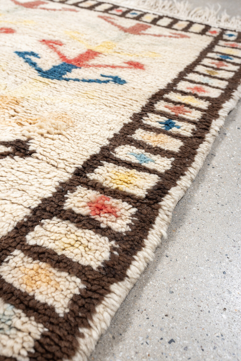 4' x 6' one-of-a-kind handmade vintage Moroccan small size rug. Color palette: ivory, brown, blue, coral, yellow, olive