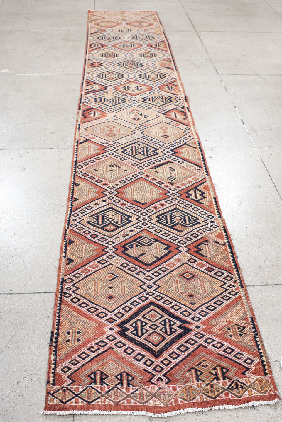 2' x 12' one-of-a-kind handmade vintage Jijim runner rug. Color palette: ivory, terra cotta, charcoal, rust, camel