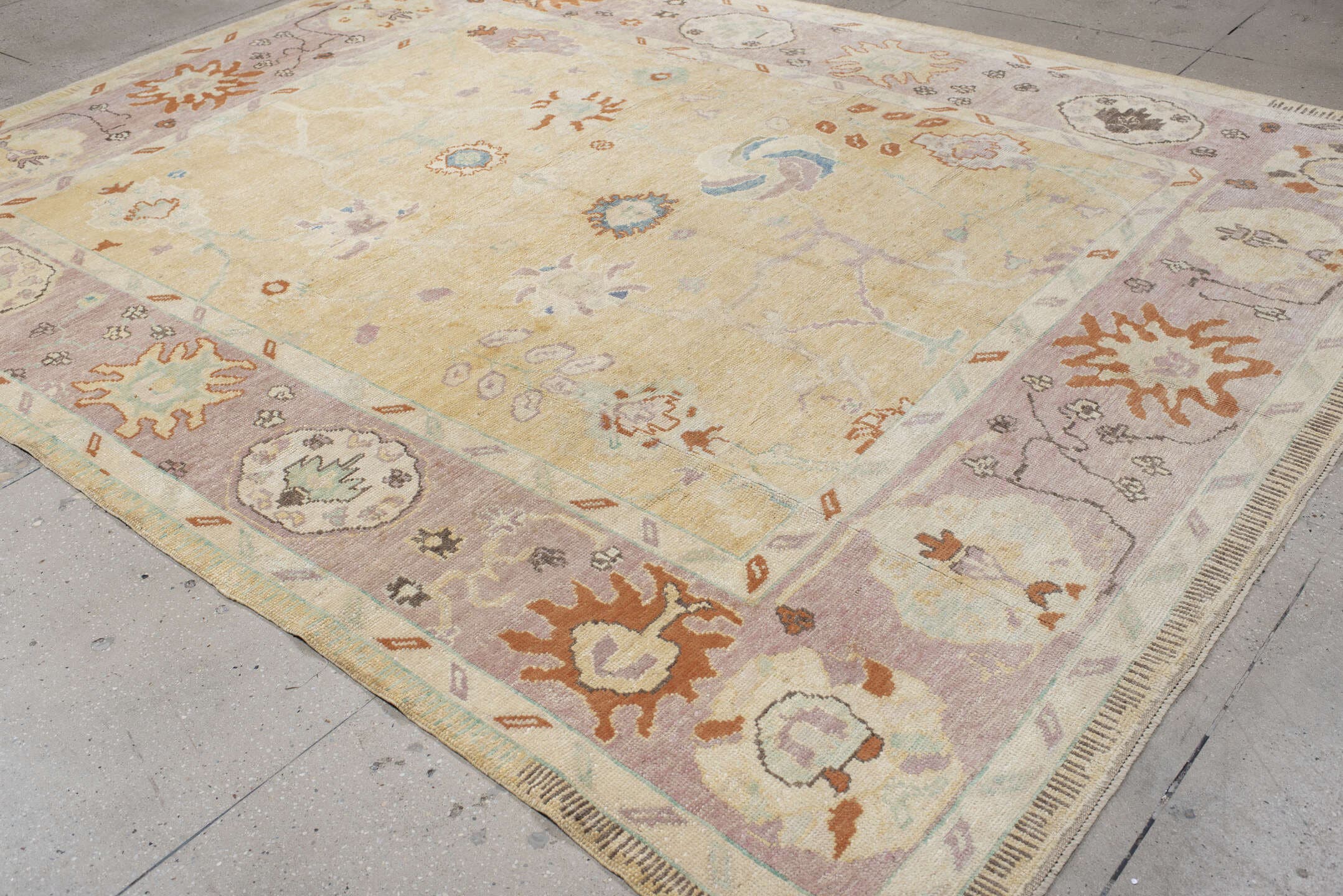 9' x 11' one-of-a-kind handmade vintage Oushak large size rug. Color palette: ivory, lavender, peach, pale gold, sky blue