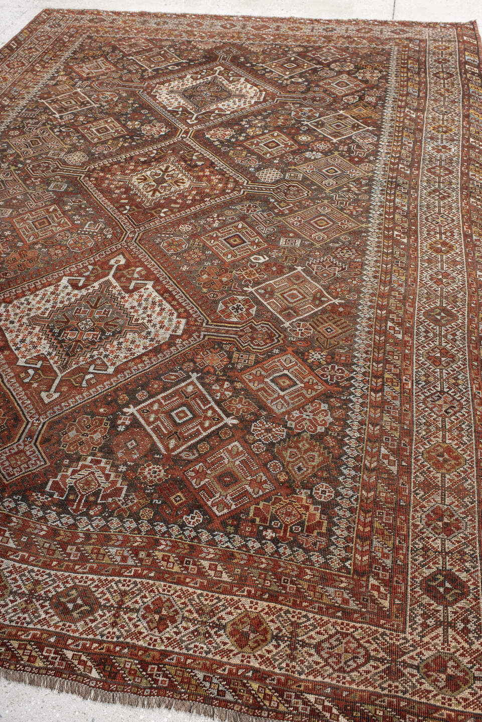 7' x 10' one-of-a-kind handmade antique Shiraz large size rug. Color palette: rust, ivory, brown, terra cotta, charcoal