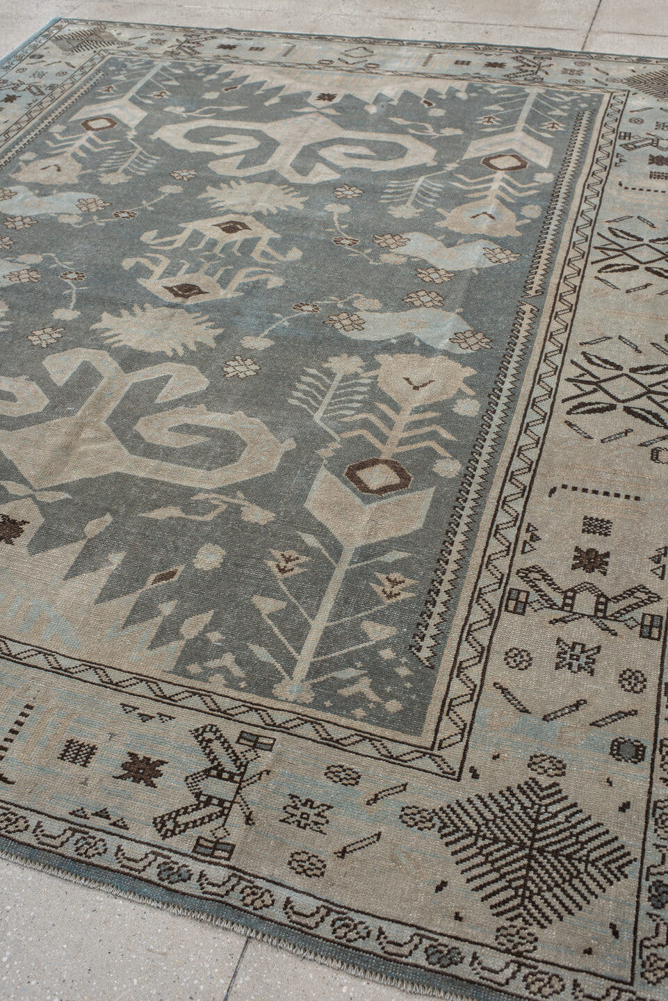 7' x 9' one-of-a-kind handmade vintage Anatolian rug. Color palette: ivory, slate, taupe, charcoal, brown, pale blue, gray