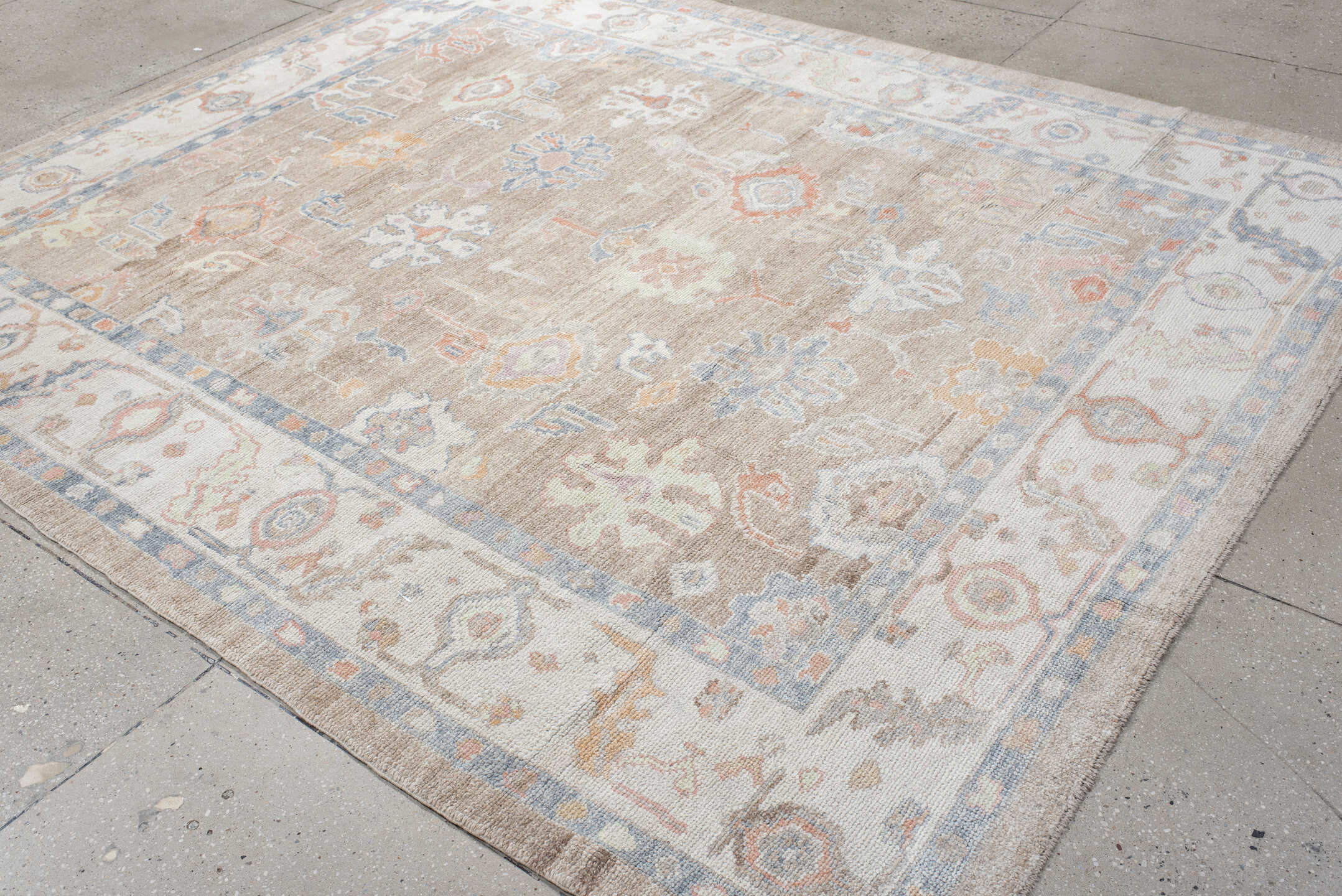 8' x 9' one-of-a-kind handmade vintage Oushak rug. Color palette: taupe, ivory, pale blue, coral, peach, beige, sage, gray