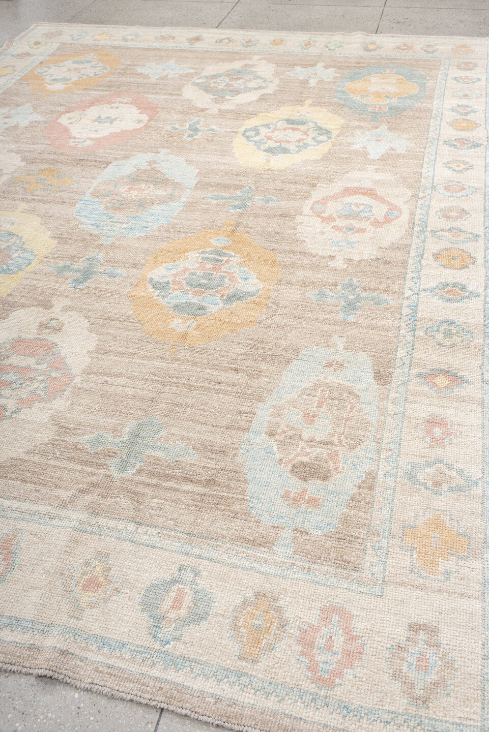 9' x 12' one-of-a-kind handmade vintage Oushak large size rug. Color palette: taupe, ivory, pale blue, peach, soft gold