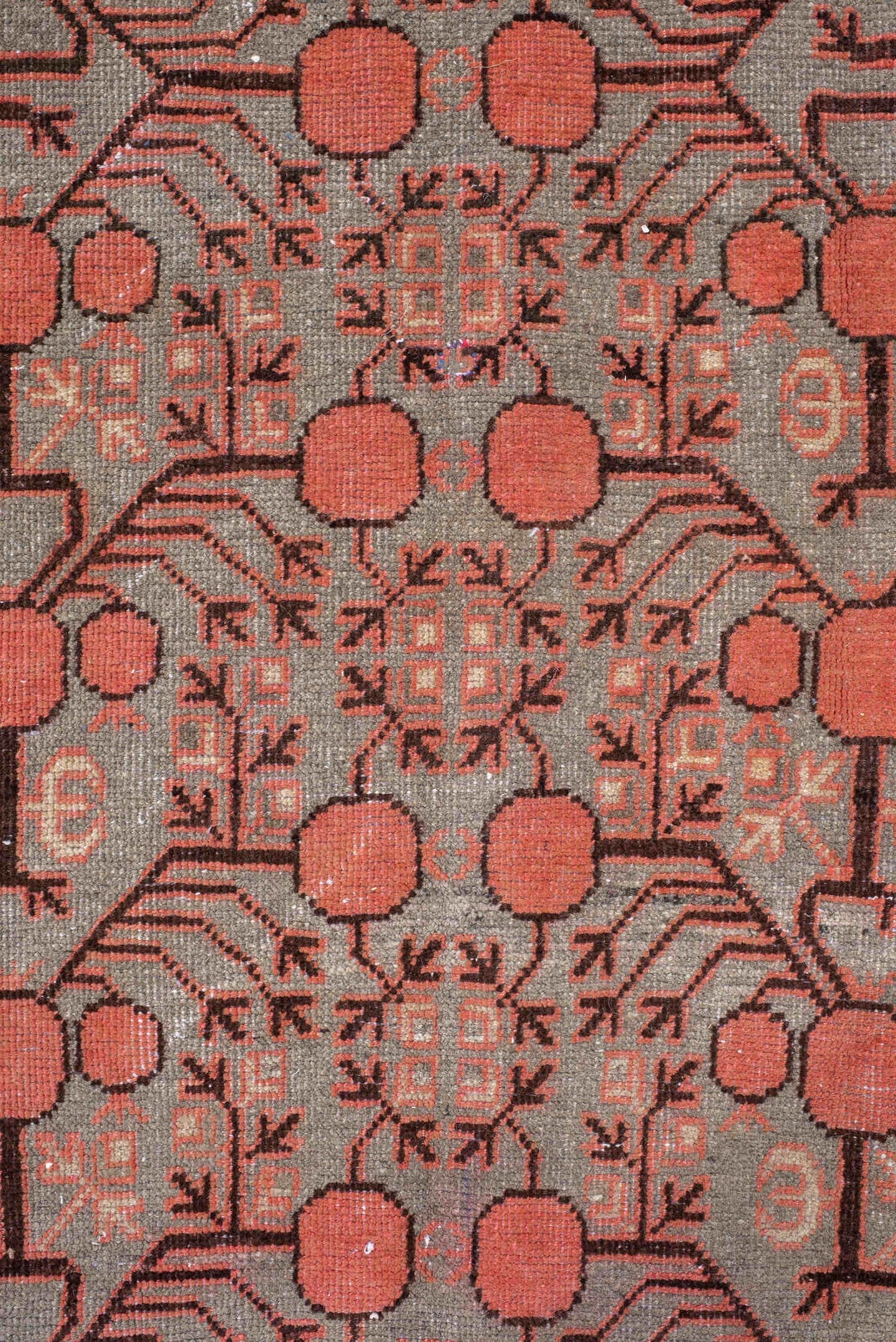 5' x 9' one-of-a-kind handmade antique Khotan medium size rug. Color palette: terra cotta, taupe, charcoal, ivory, rust