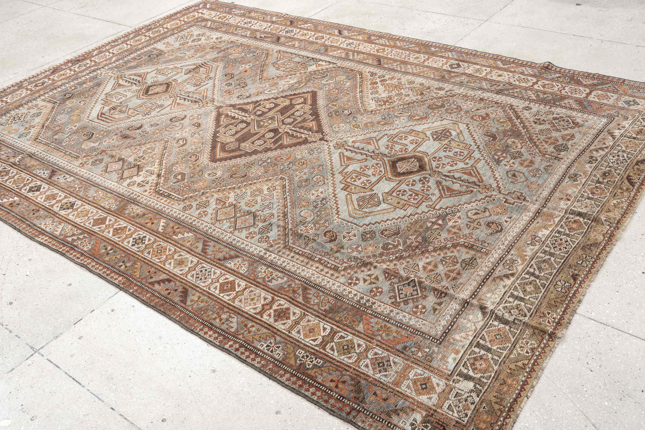 6' x 9' one-of-a-kind handmade antique Qashqai rug. Color palette: taupe, ivory, rust, slate, brown, camel, charcoal, beige